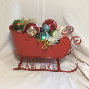 Hand arranged Christmas ornaments in a sleigh